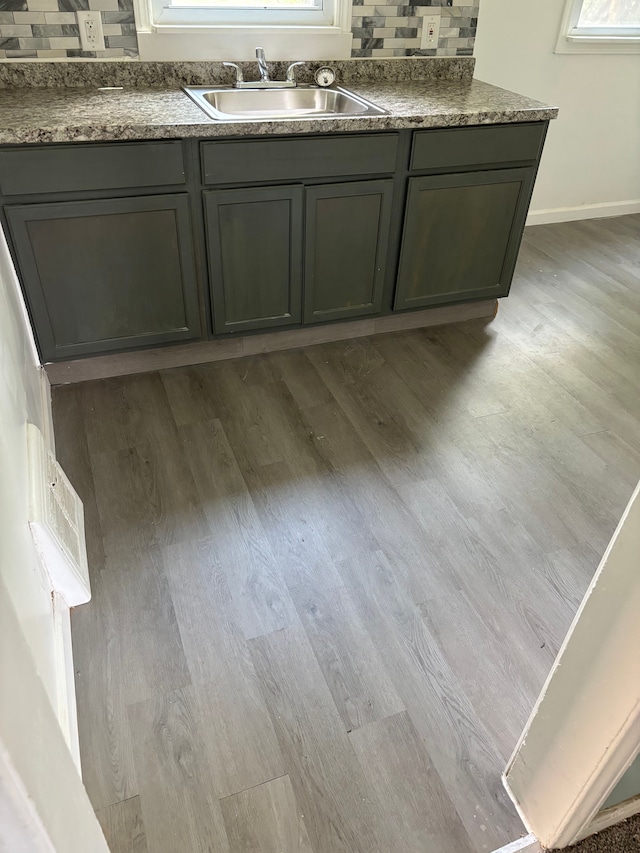 bathroom featuring vanity, wood-type flooring, and backsplash