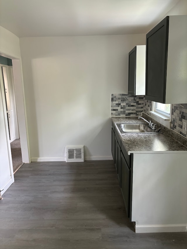 kitchen with decorative backsplash, dark hardwood / wood-style floors, and sink