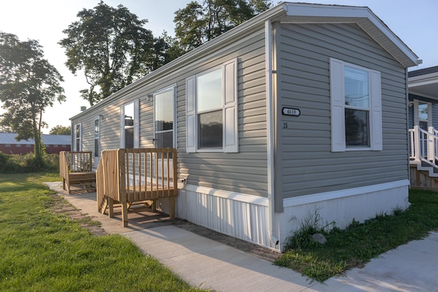 view of side of home with a lawn