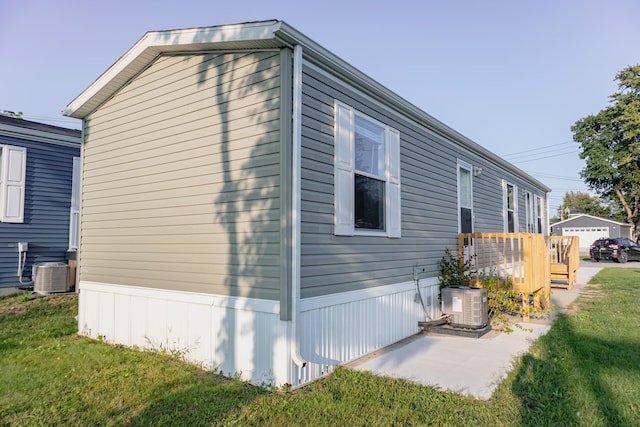 view of home's exterior featuring a yard and central AC