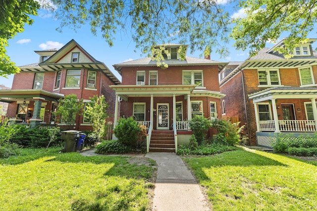 view of front of home with covered porch and a front yard