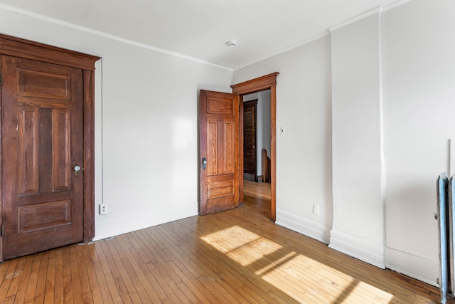 interior space featuring hardwood / wood-style flooring and crown molding