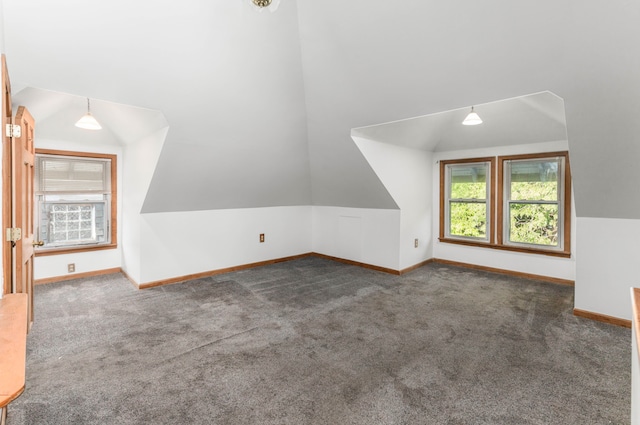 bonus room featuring dark colored carpet and vaulted ceiling