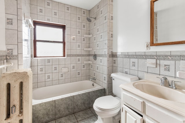 3937 Avery St, Detroit, MI 48208 - bathroom featuring tile walls, toilet, tile patterned flooring, tiled shower / bath combo, and vanity