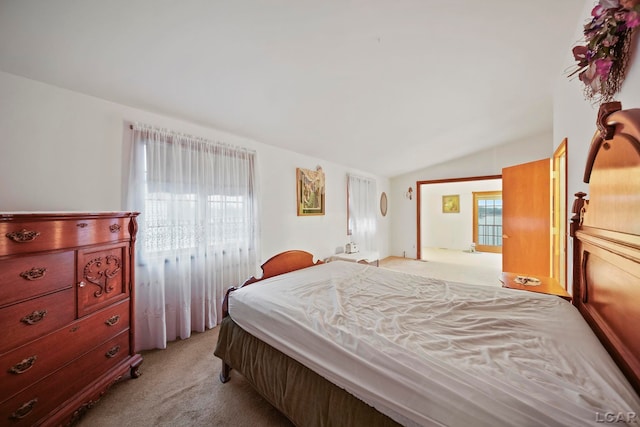 bedroom featuring light colored carpet and lofted ceiling