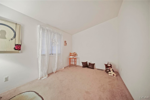 unfurnished room with carpet flooring and vaulted ceiling