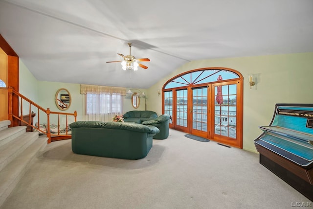 carpeted living room with vaulted ceiling and ceiling fan