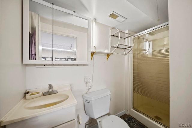 bathroom with vanity, a shower with shower door, and toilet