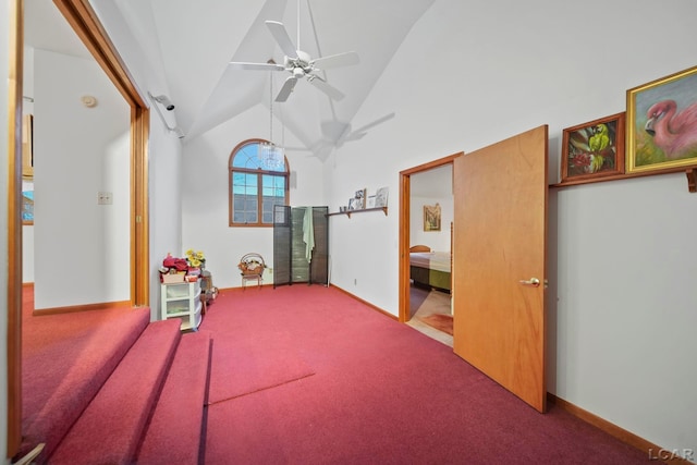 bedroom with carpet flooring, ceiling fan, and high vaulted ceiling