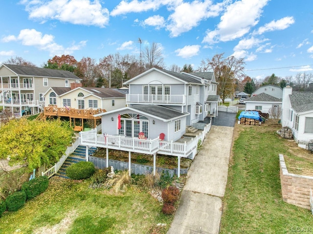 rear view of house featuring a yard