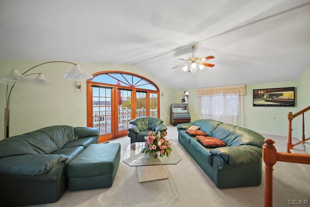 carpeted living room with a wealth of natural light, ceiling fan, and lofted ceiling