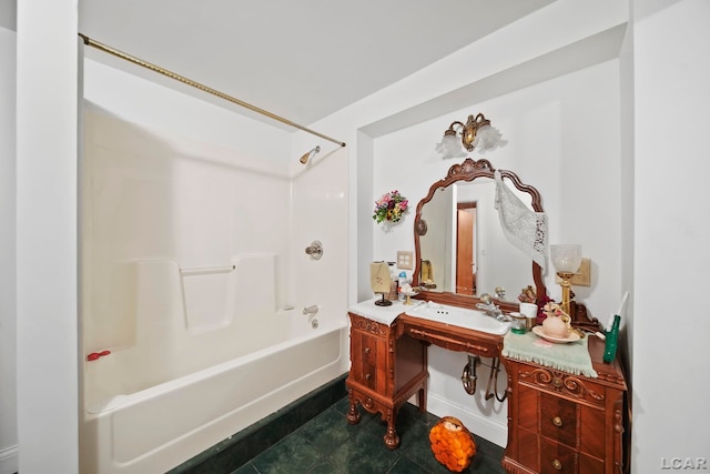 bathroom featuring tile patterned flooring,  shower combination, and sink