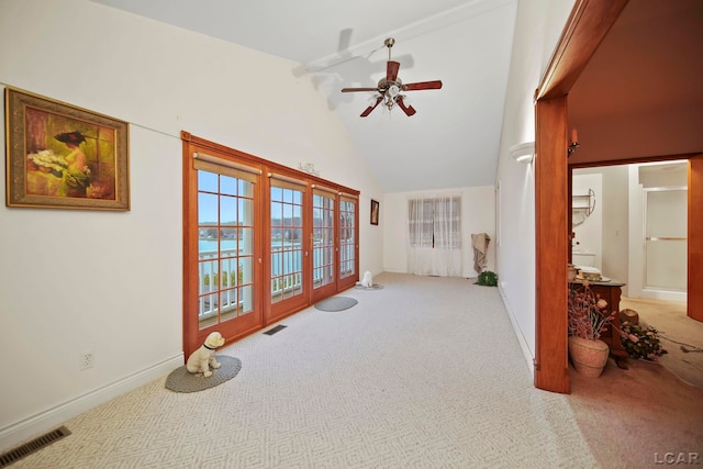 interior space with light colored carpet, high vaulted ceiling, and ceiling fan