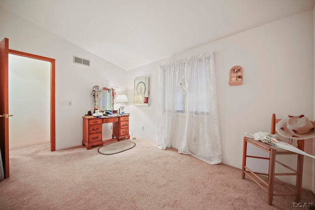 interior space with light colored carpet and vaulted ceiling