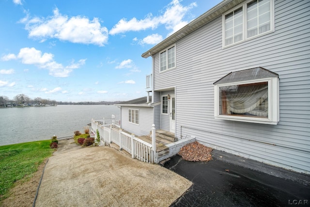 view of property exterior with a water view