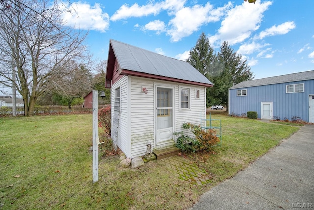 view of outbuilding with a lawn