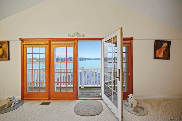 doorway to outside with vaulted ceiling, a water view, carpet floors, and french doors