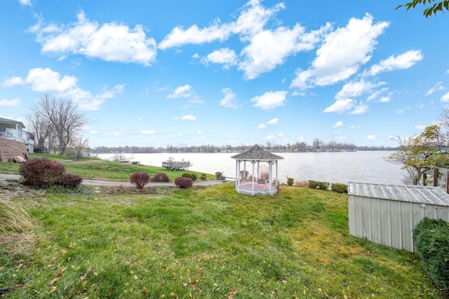 view of yard featuring a gazebo and a water view