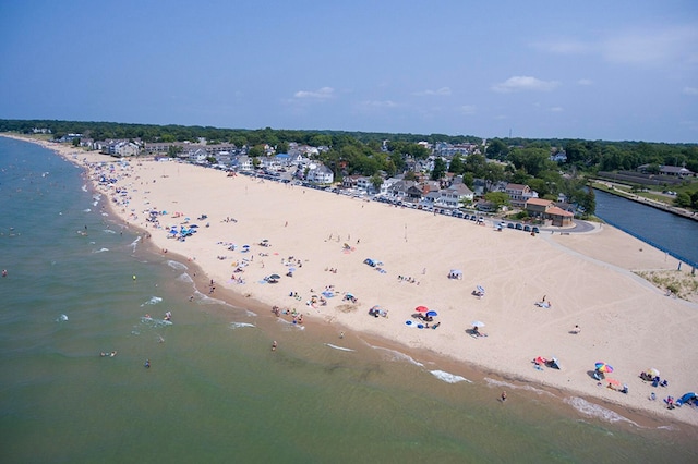 drone / aerial view featuring a water view and a beach view