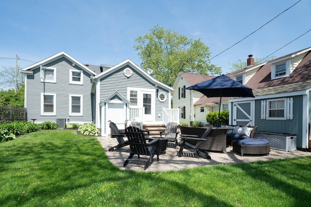 back of house featuring a lawn, central air condition unit, and a patio