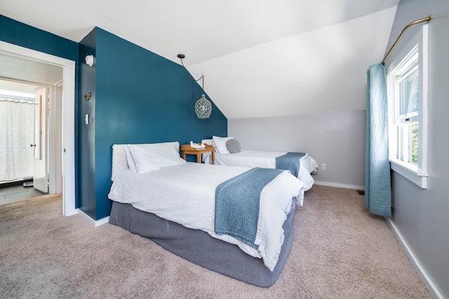 carpeted bedroom featuring lofted ceiling