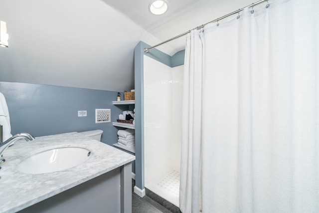 bathroom with curtained shower, vanity, and lofted ceiling