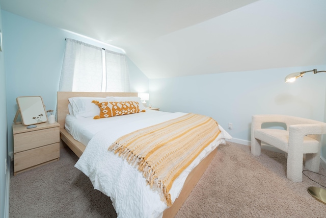 bedroom with lofted ceiling and carpet floors