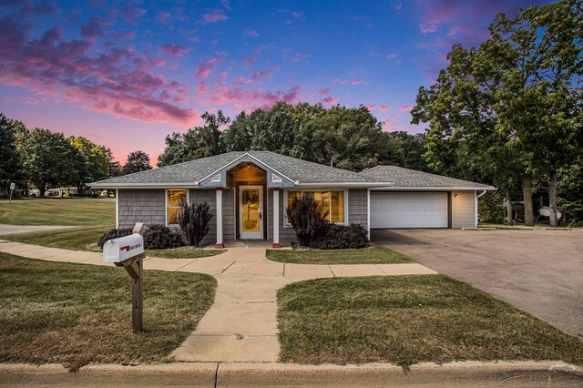 ranch-style home with a lawn and a garage