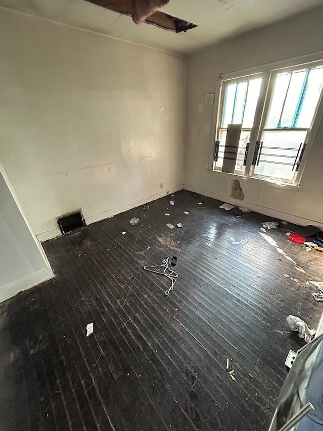 unfurnished room with dark hardwood / wood-style floors