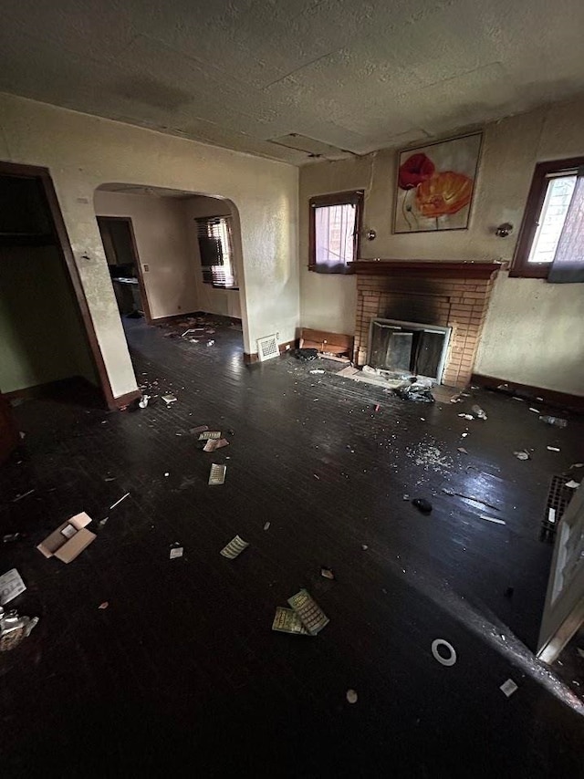 miscellaneous room featuring a fireplace and plenty of natural light