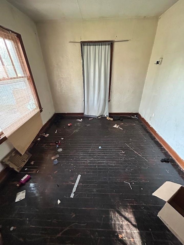 spare room with dark wood-type flooring