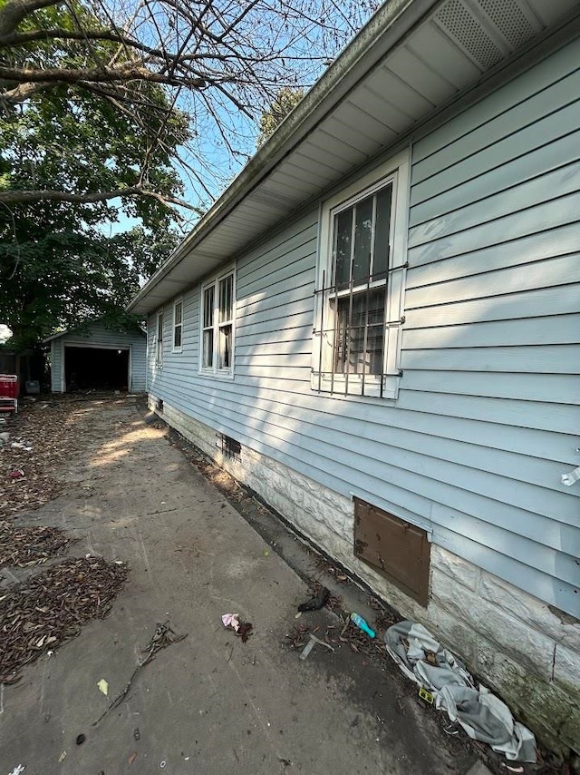 view of property exterior featuring a garage and an outdoor structure