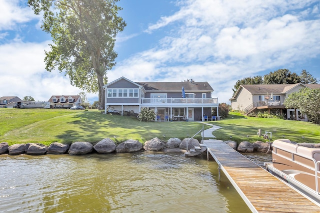 view of dock featuring a lawn and a water view