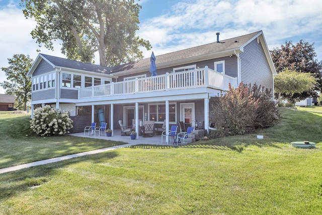 back of property featuring a patio, a deck, a lawn, and a sunroom