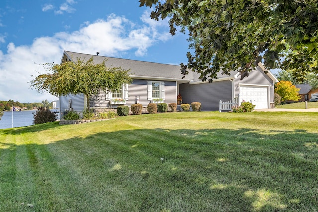 view of front of house with a front yard and a garage