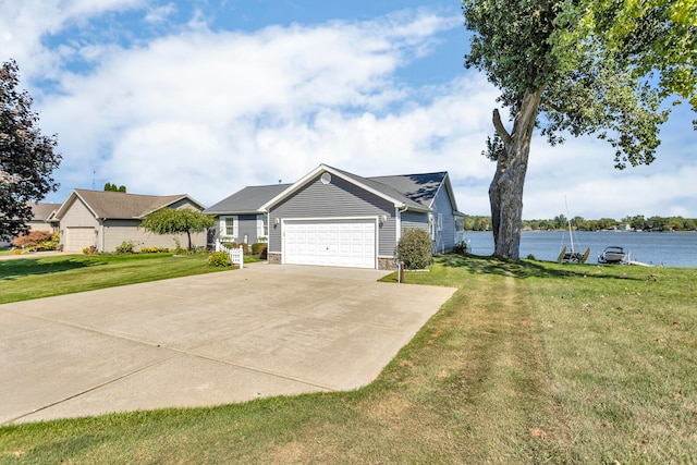 single story home with a water view, a garage, and a front lawn