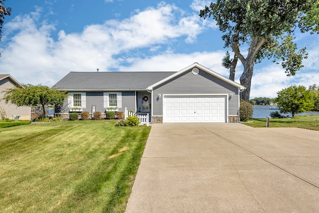 ranch-style house with a water view, a front lawn, and a garage