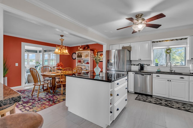 kitchen featuring crown molding, white cabinetry, sink, and stainless steel appliances