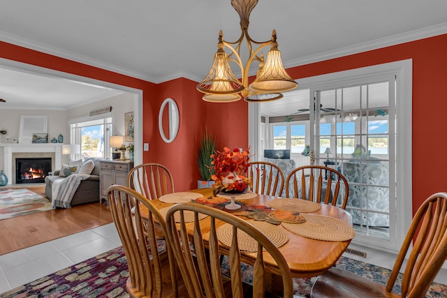 dining room featuring light tile patterned floors, ceiling fan, and crown molding