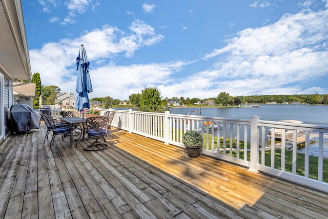 wooden deck featuring area for grilling and a water view