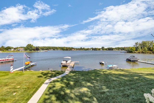 dock area with a yard and a water view