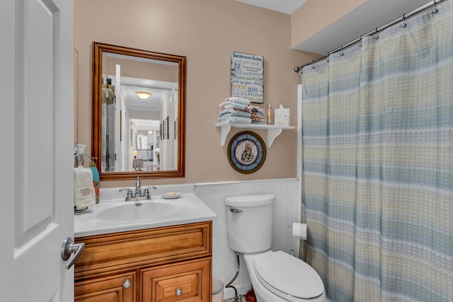 bathroom featuring vanity, toilet, and walk in shower