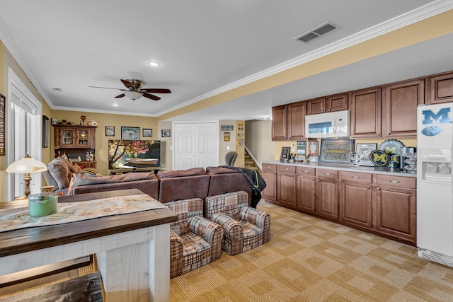 kitchen featuring light carpet, white appliances, ceiling fan, and crown molding