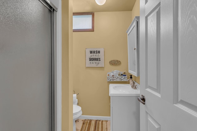 bathroom with vanity, toilet, and a shower with shower door