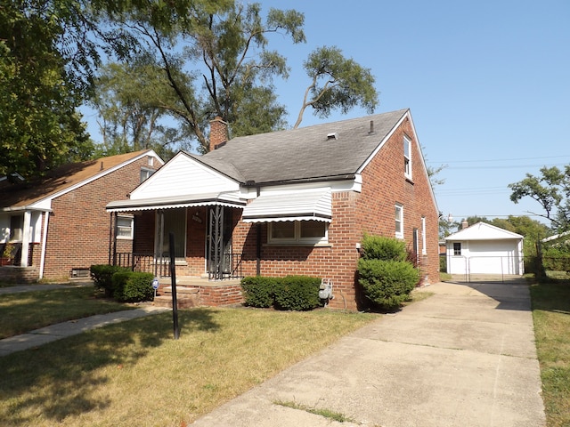 bungalow-style house featuring an outbuilding, a garage, a front lawn, and covered porch