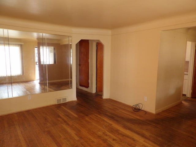 spare room with dark wood-type flooring