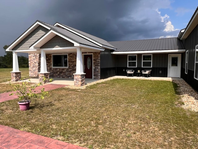 view of front of property with a porch and a front yard