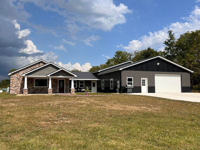 view of front of house with covered porch, a front yard, and a garage