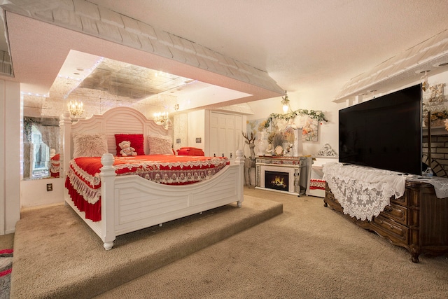 carpeted bedroom with a textured ceiling and an inviting chandelier