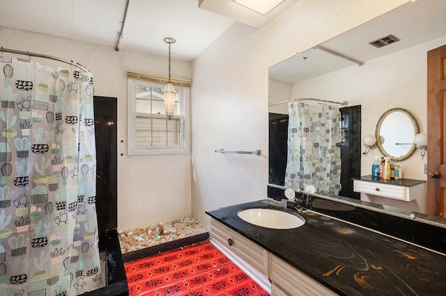 bathroom featuring vanity and a shower with shower curtain